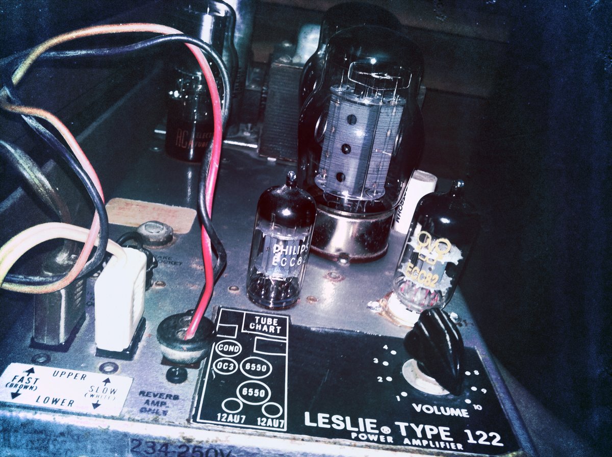 The Leslie 122 amplifier chassis, showing the multi-section filter capacitor, the 6550A output pair and 12AU7A driver, and the speed-changeover relay that are the recap/retube and cleaning targets