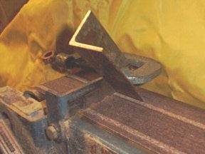 Figure 2 — Mitred stopped bass pipes folded under the skirt of a John Smith organ, with the small octave "helper" pipes mounted separately above the bellows.