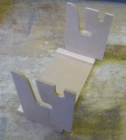 Figure 2 — A Raffin-compatible supply spool seated in the spool holder, showing the end socket used for the 5 mm hex rewind and the side spacers that set lateral tracking without rims dragging on the paper edge.