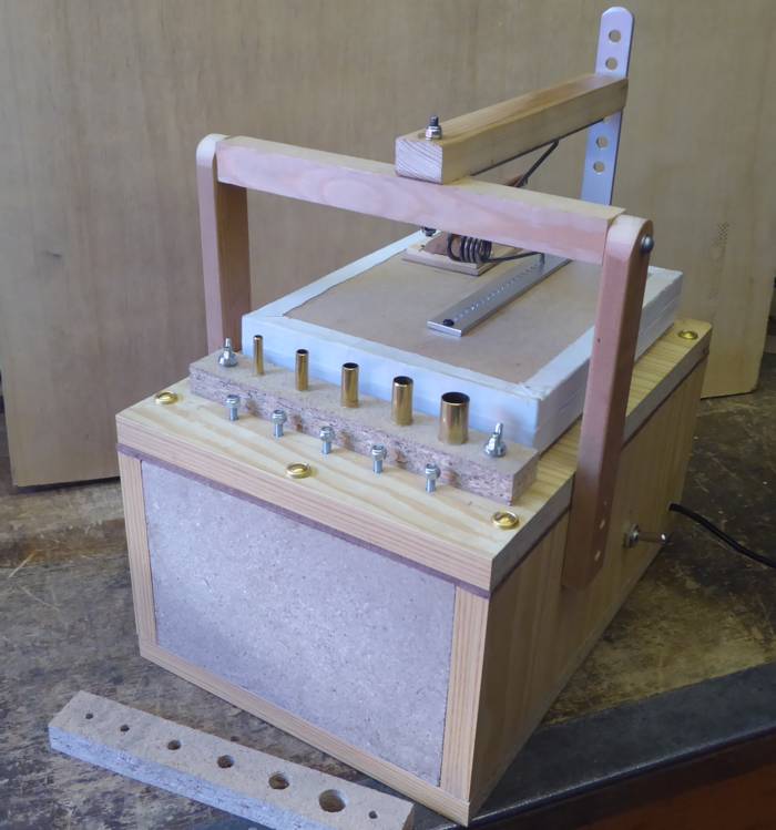 Figure 3 — A pipe-voicing machine (jig): a single valved wind outlet fed from a reservoir set to 5 in H2O against a manometer, into which one pipe at a time is seated so its cut-up and foot-hole can be dialle…