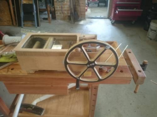 Figure 2 — A hobby busker organ with the case open, showing the crankshaft, con-rods to the feeders, and the driving-wheel-to-take-up drive train.